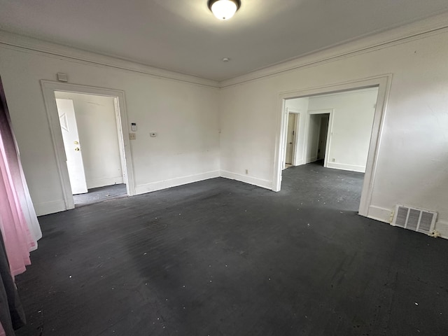 unfurnished room with crown molding