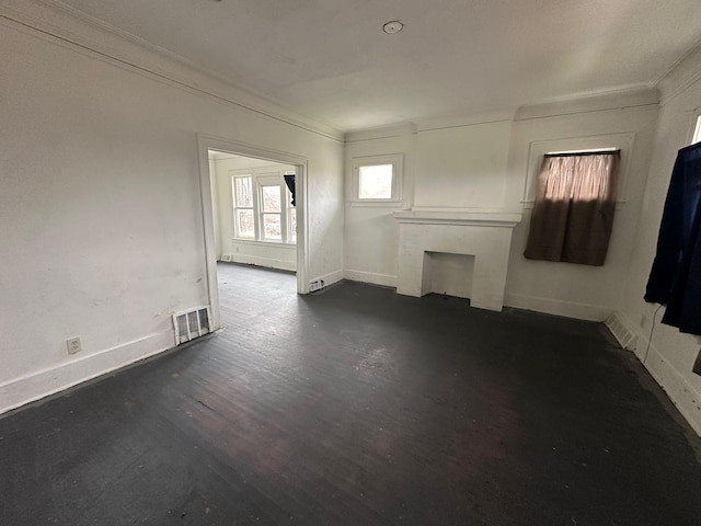 empty room with dark hardwood / wood-style flooring and crown molding