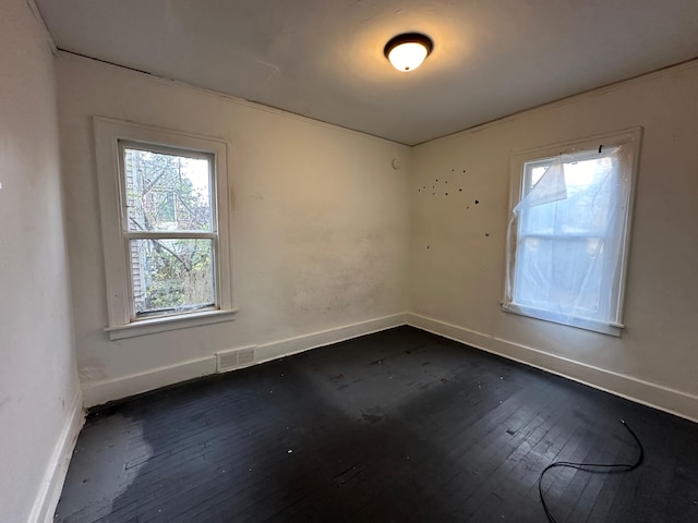 empty room with dark wood-type flooring