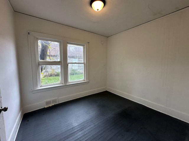 spare room featuring dark hardwood / wood-style flooring