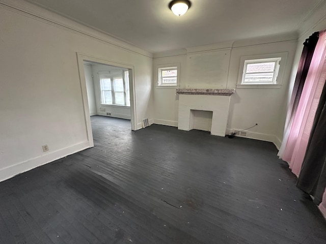 unfurnished living room featuring dark wood-type flooring and ornamental molding