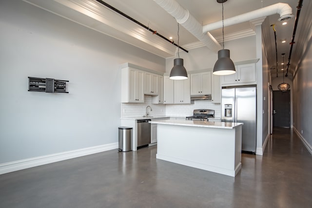 kitchen featuring a center island, hanging light fixtures, stainless steel appliances, backsplash, and white cabinets