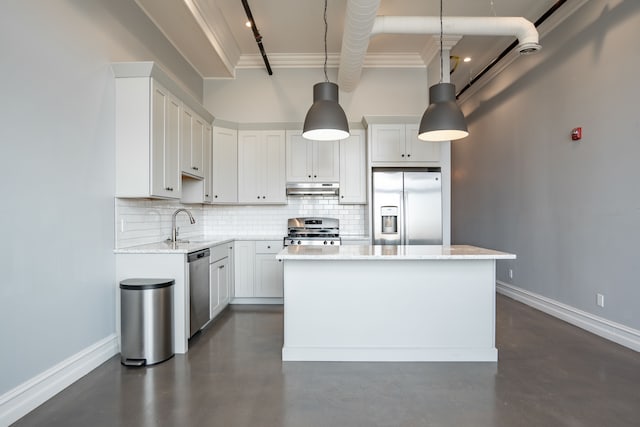 kitchen with decorative light fixtures, a kitchen island, white cabinetry, and stainless steel appliances