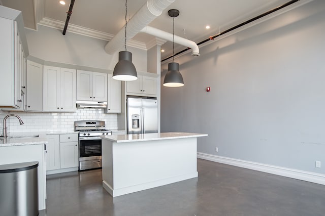 kitchen featuring sink, decorative light fixtures, a kitchen island, white cabinetry, and stainless steel appliances