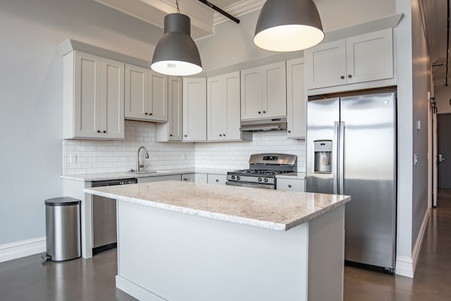 kitchen featuring backsplash, sink, decorative light fixtures, light stone counters, and stainless steel appliances