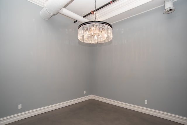 empty room featuring an inviting chandelier