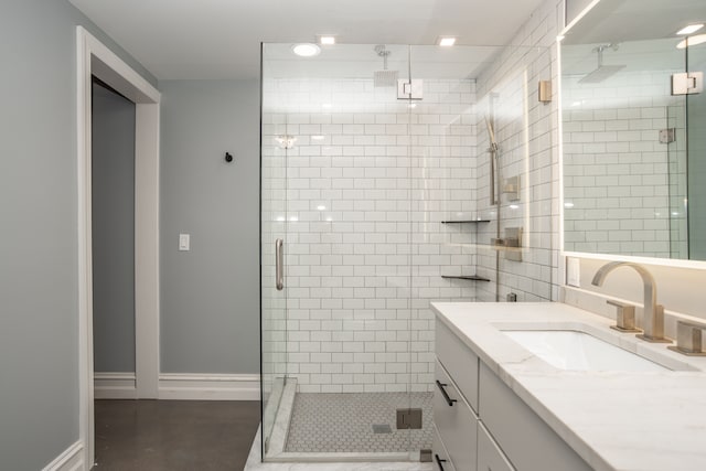 bathroom with concrete flooring, vanity, and walk in shower