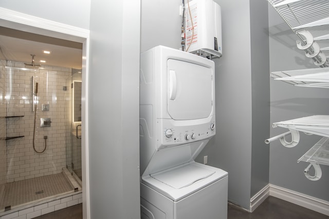 laundry area featuring stacked washing maching and dryer and water heater