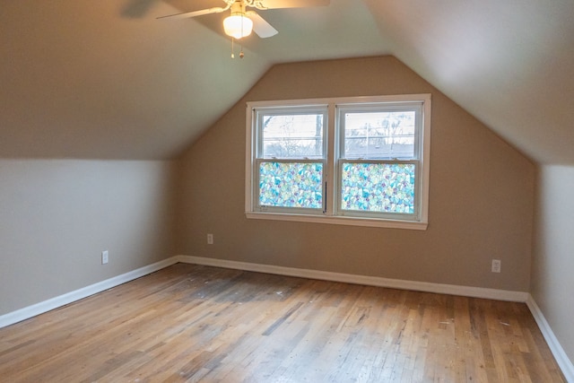 additional living space featuring lofted ceiling, ceiling fan, and light wood-type flooring