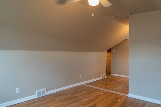 additional living space with lofted ceiling, hardwood / wood-style flooring, and ceiling fan