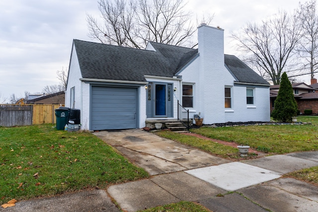 view of front of property with a garage and a front yard