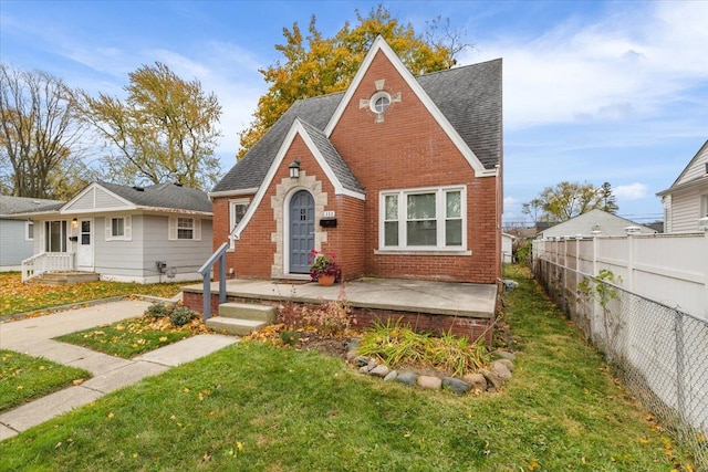 view of front of home with a front lawn and a patio