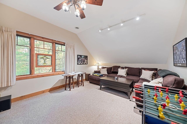 carpeted living room with track lighting, ceiling fan, and lofted ceiling