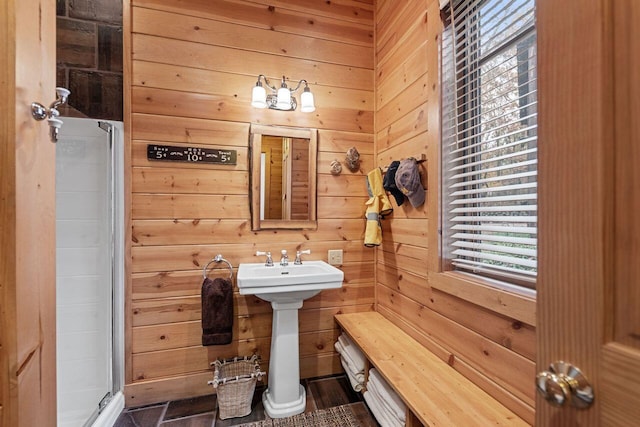 bathroom featuring wood walls and an enclosed shower