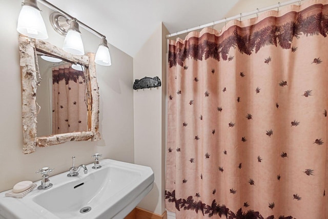 bathroom with sink and vaulted ceiling