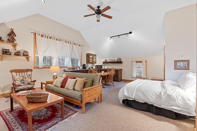 bedroom with ceiling fan, carpet floors, and vaulted ceiling