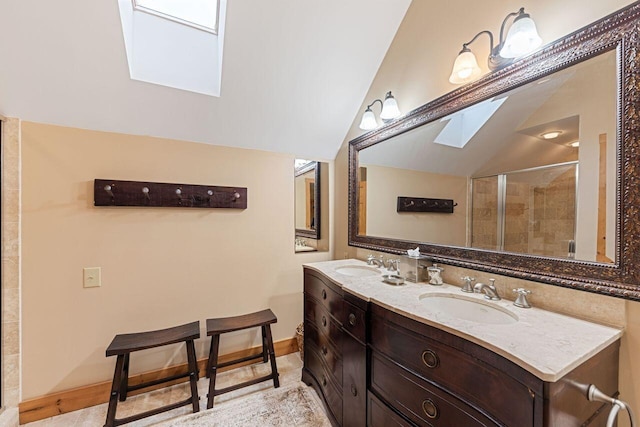 bathroom with vaulted ceiling with skylight, vanity, and walk in shower