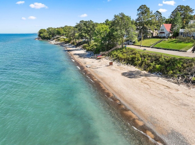 drone / aerial view featuring a water view and a beach view