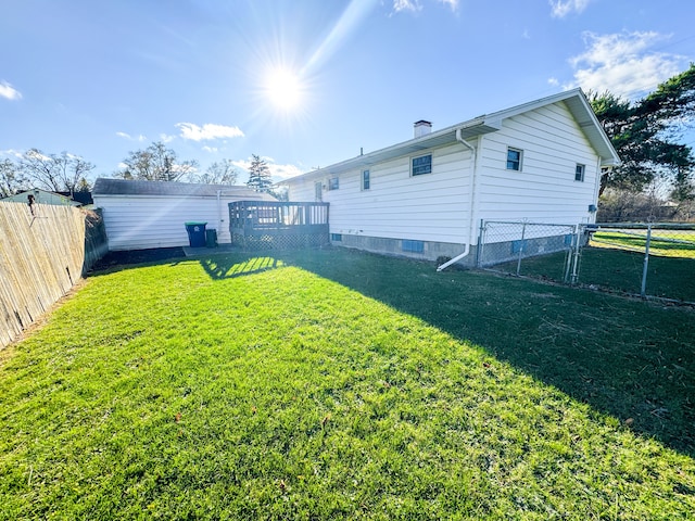 back of property with a yard and a deck