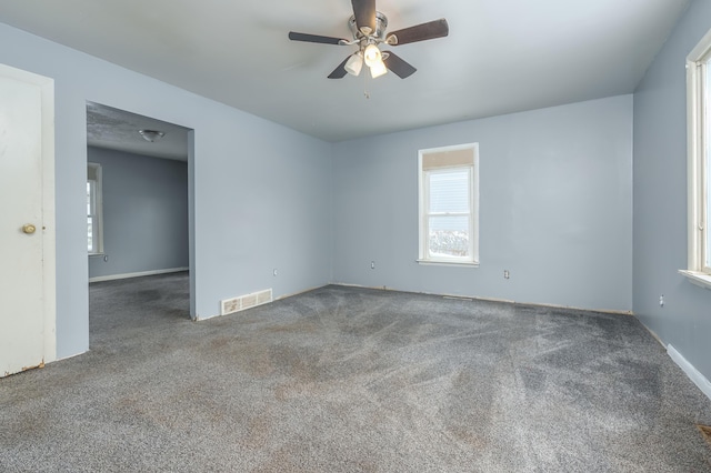 carpeted spare room with ceiling fan