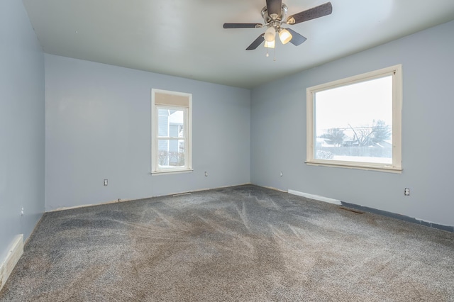 carpeted empty room featuring ceiling fan