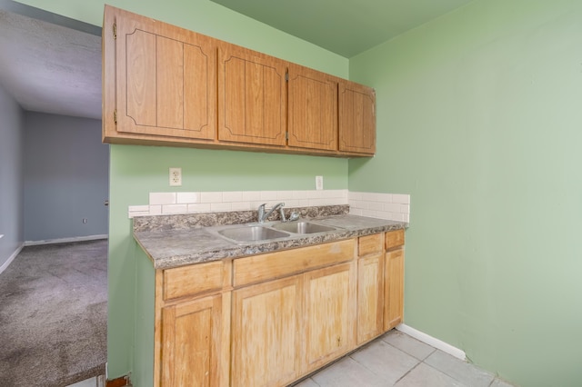 kitchen featuring sink and light carpet