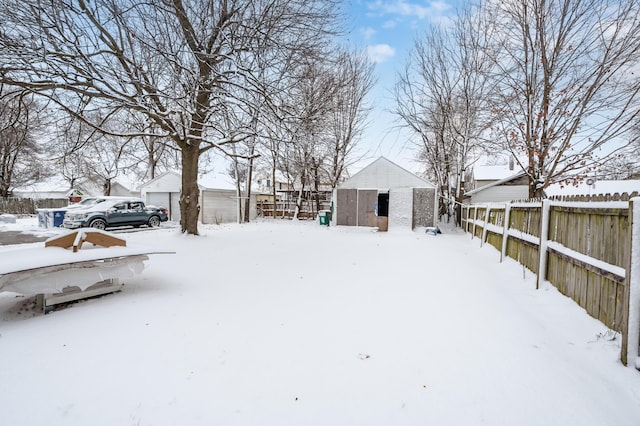 snowy yard with an outbuilding