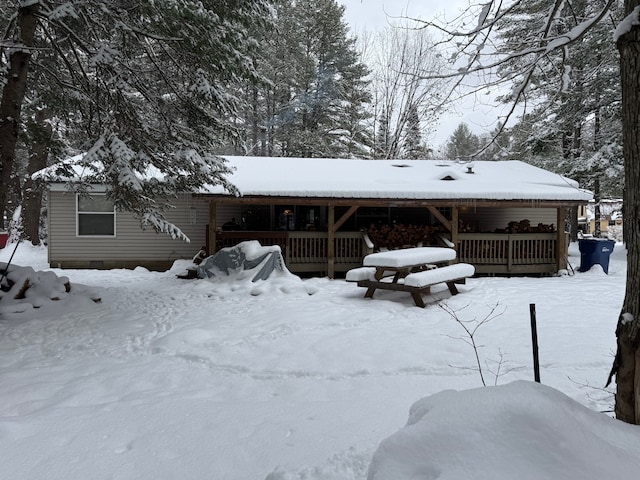 view of snow covered rear of property