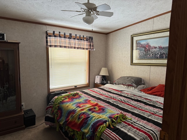 bedroom featuring ceiling fan, crown molding, carpet floors, and a textured ceiling