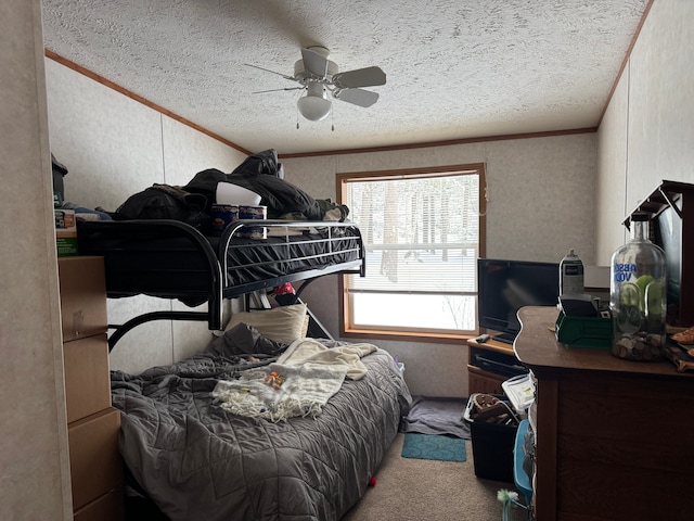 carpeted bedroom featuring a textured ceiling, ceiling fan, and crown molding