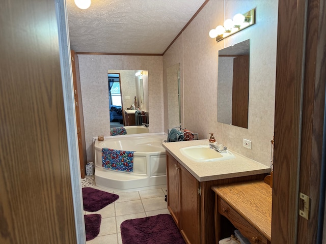 bathroom featuring tile patterned floors, a tub to relax in, a textured ceiling, vanity, and ornamental molding