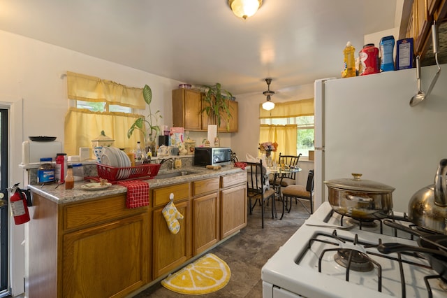 kitchen featuring white appliances and sink