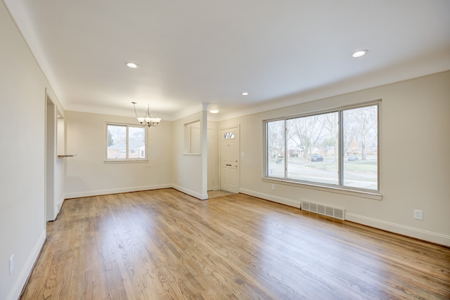 interior space featuring a chandelier and light hardwood / wood-style floors