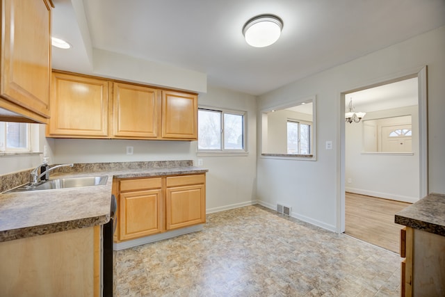 kitchen featuring an inviting chandelier and sink