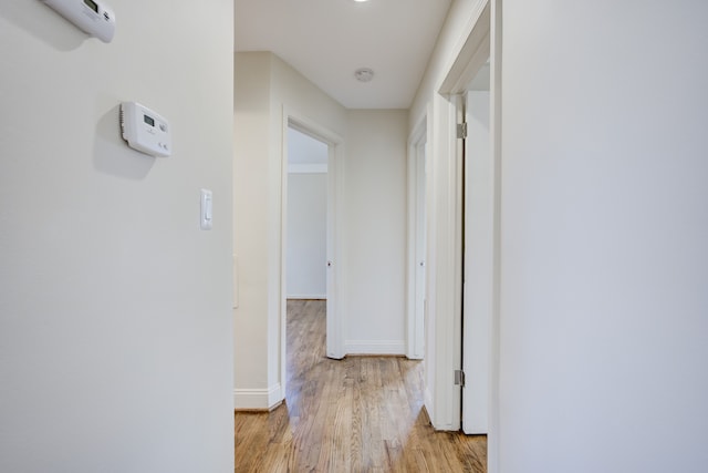 corridor with light hardwood / wood-style flooring