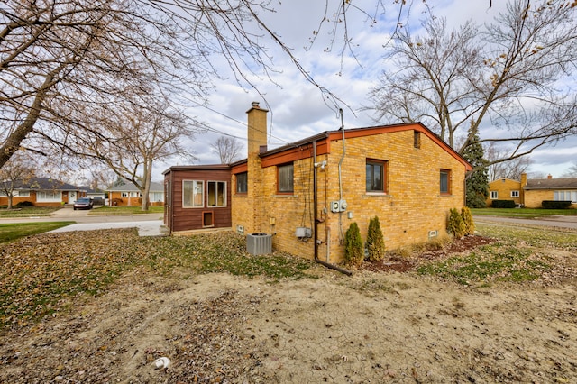 view of side of home featuring central AC unit