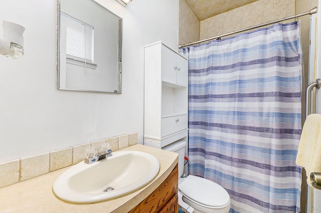 bathroom with vanity, toilet, and curtained shower