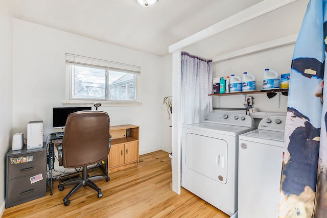 washroom featuring light hardwood / wood-style flooring and washing machine and clothes dryer