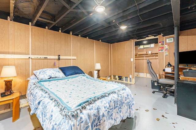 bedroom with concrete floors, a closet, and wooden walls