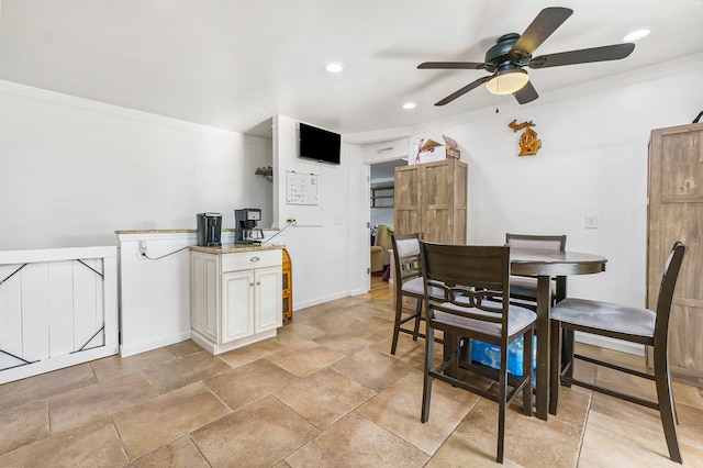 dining area featuring ceiling fan and crown molding