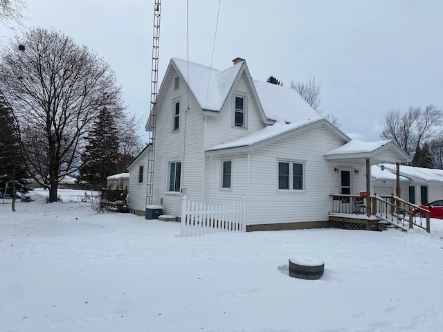 view of snow covered back of property