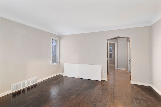 unfurnished room featuring dark hardwood / wood-style flooring