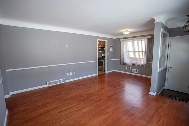 unfurnished room featuring dark wood-type flooring