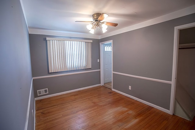 unfurnished bedroom with hardwood / wood-style flooring, ceiling fan, and a closet