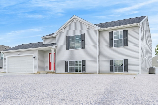 tri-level home with a garage and central air condition unit