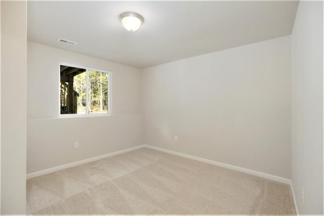 spare room with light colored carpet