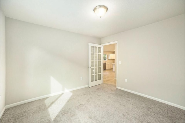 unfurnished room with carpet flooring and french doors