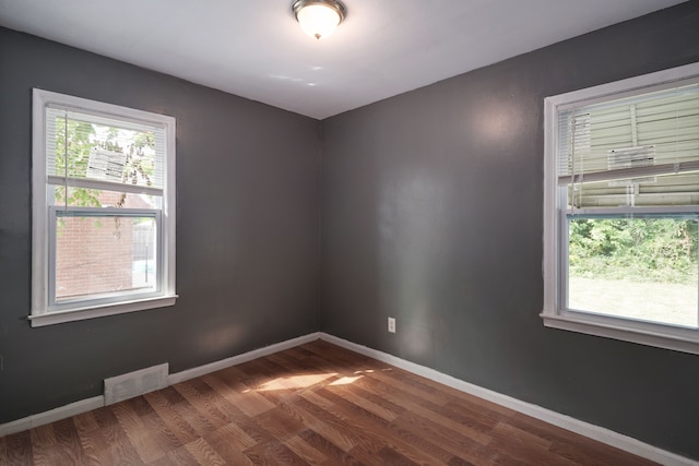 empty room with dark hardwood / wood-style floors