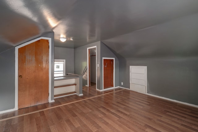 bonus room featuring wood-type flooring and vaulted ceiling