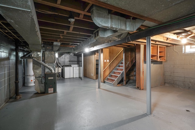 basement with washer and dryer and heating unit